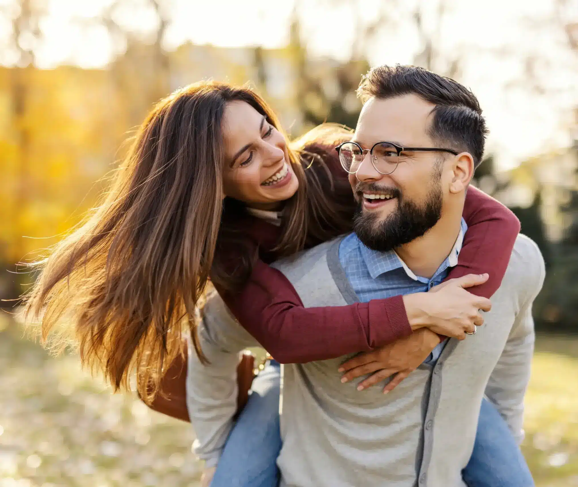 Smiling couple outdoors enjoying time together with healthy, confident smiles