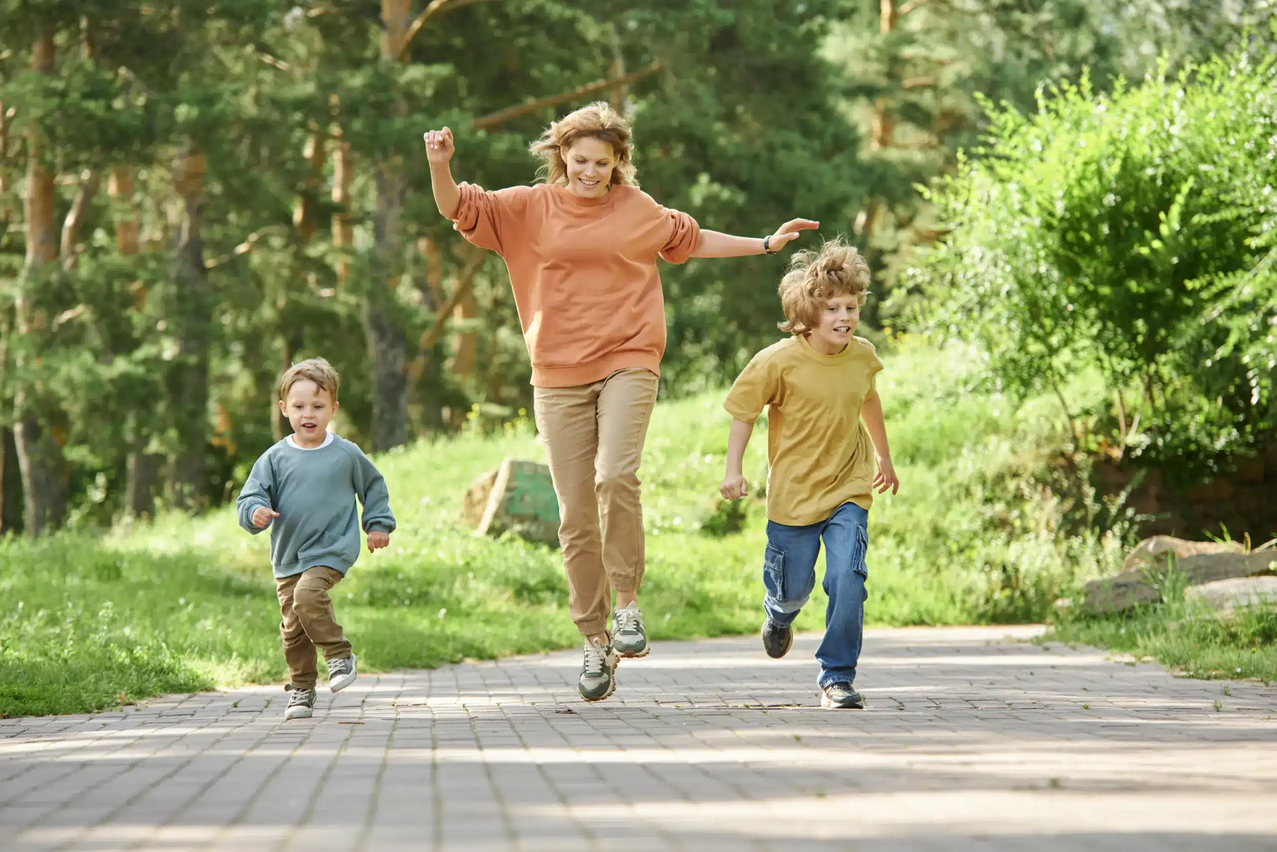 Happy family walking outdoors together, representing healthy lifestyle and overall wellness